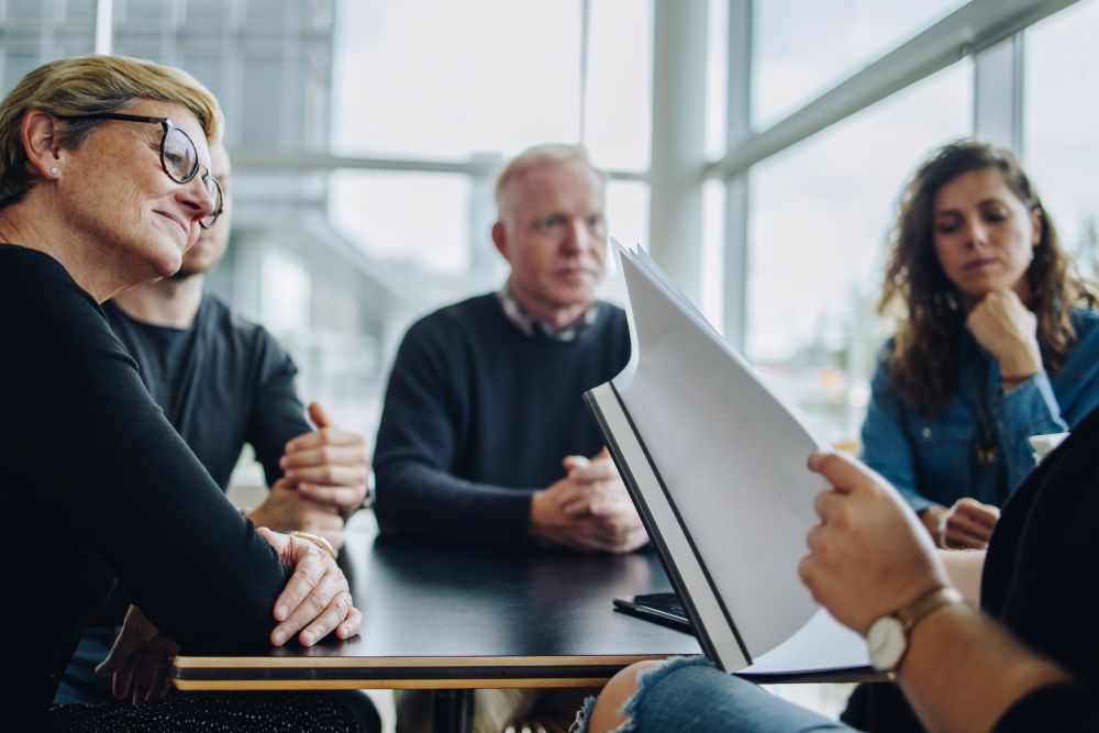 employees reviewing handbook